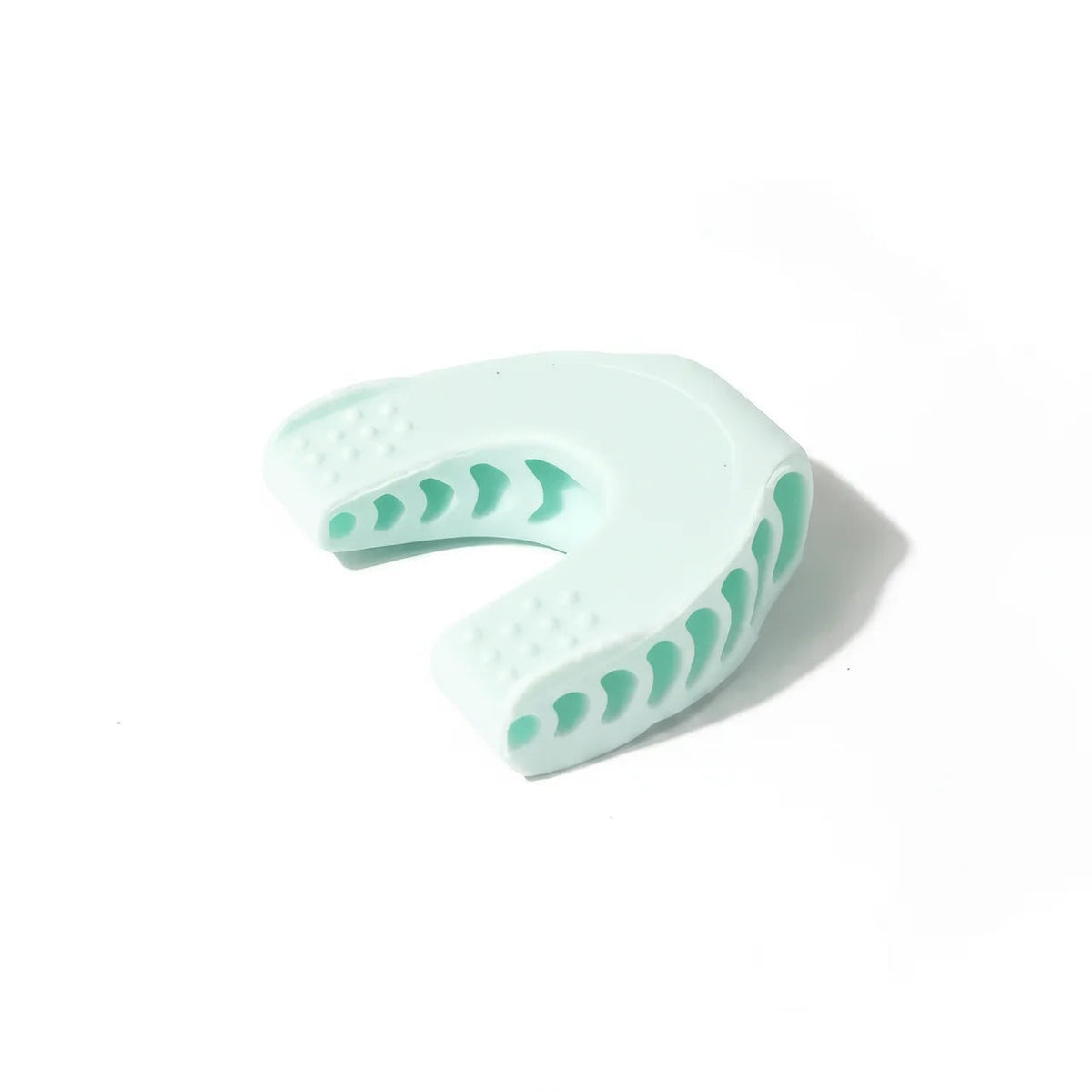 Light blue dental impression tray with green patterns on a white background