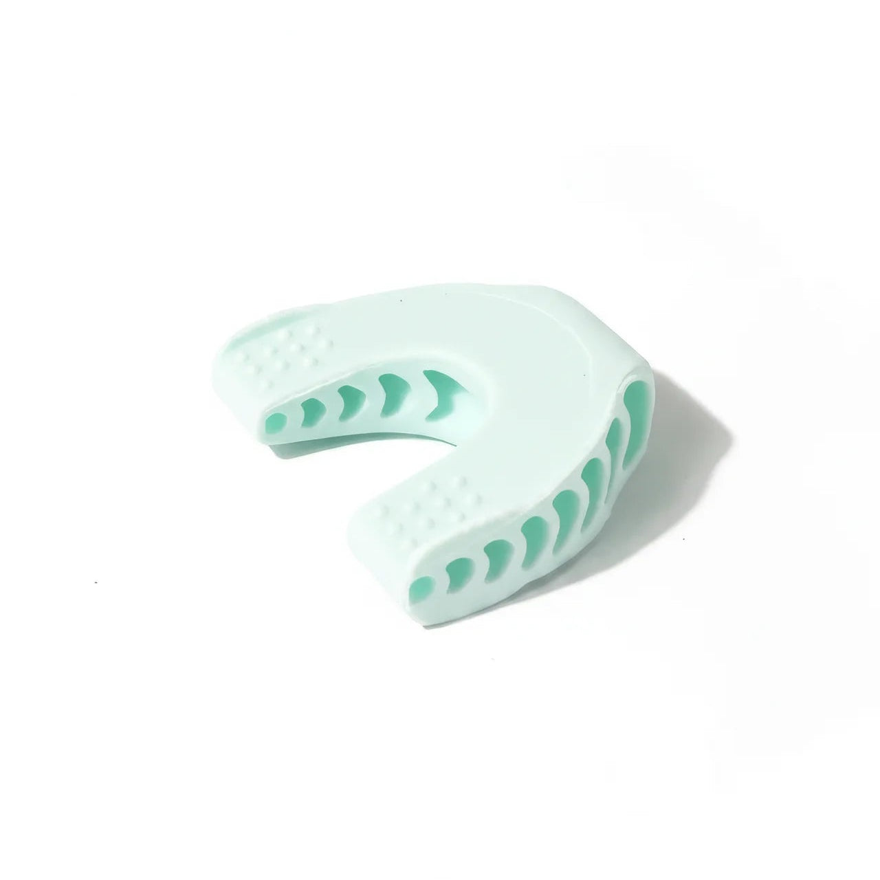 Light blue dental impression tray with green patterns on a white background