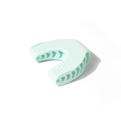 Light blue dental impression tray with green patterns on a white background