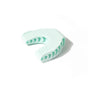 Light blue dental impression tray with green patterns on a white background